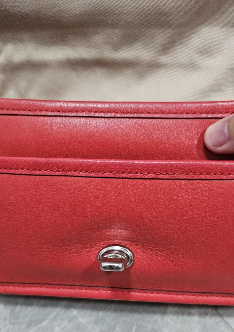 Coach Legacy Penny Crossbody Bag (Category: Luxury Bags & Wallets) located in Antipolo. Submitted by jlaur26 (Listing ID 1367014697, Image 3). Description: Authentic coach penny legacy crossbody bag in red color. Some issues sa hardware (pls see photos). torn na rin yung tag but it's there sa loob ng bag. 😅 Creed is intact. rfs: decluttering. price slightly negotiable. delivery fee to be shouldered by buyer..