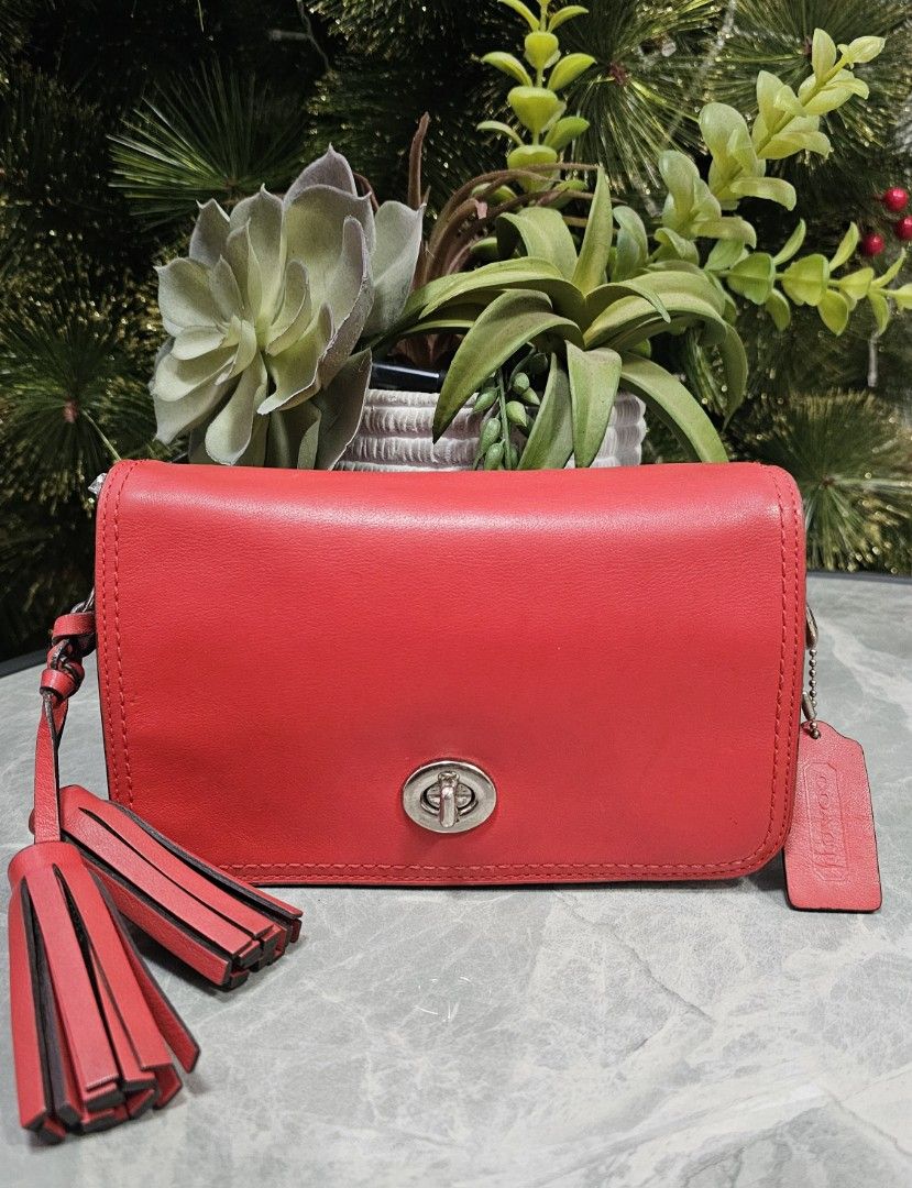 Coach Legacy Penny Crossbody Bag (Category: Luxury Bags & Wallets) located in Antipolo. Submitted by jlaur26 (Listing ID 1367014697, Image 1). Description: Authentic coach penny legacy crossbody bag in red color. Some issues sa hardware (pls see photos). torn na rin yung tag but it's there sa loob ng bag. 😅 Creed is intact. rfs: decluttering. price slightly negotiable. delivery fee to be shouldered by buyer..