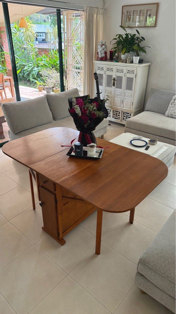 Folding Table (Category: Tables & Sets) located in Singapore. Submitted by tamaw (Listing ID 1372111170, Image 1). Description: Restored character folding table originally from London. Has cupboard and draws in the centre part. Great for tight spaces and compact living. 150cm Fully Extended (length) 40cm Folded (length) 87cm wide 74 cm Height.