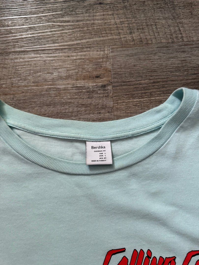 Graphic Tee (Category: Tshirts & Polo Shirts) located in Singapore. Submitted by eathand (Listing ID 1367166318, Image 3). Description: small yellow stain on the bottom front of shirt shown in pictures.