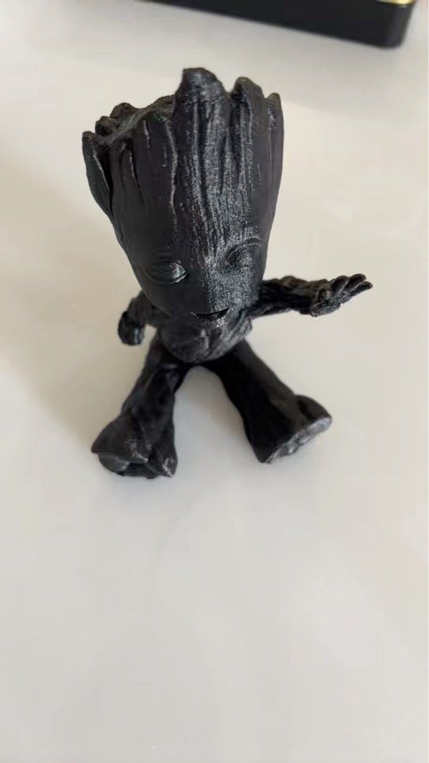 Groot Figurine (Category: Toy Figures) located in Singapore. Submitted by lhsa91 (Listing ID 1367183421, Image 1). Description: This is a cute Groot figurine, perfect for any Marvel fan! It's in lightly used condition, with no scratches or defects. It's a great addition to any collection or desk. .