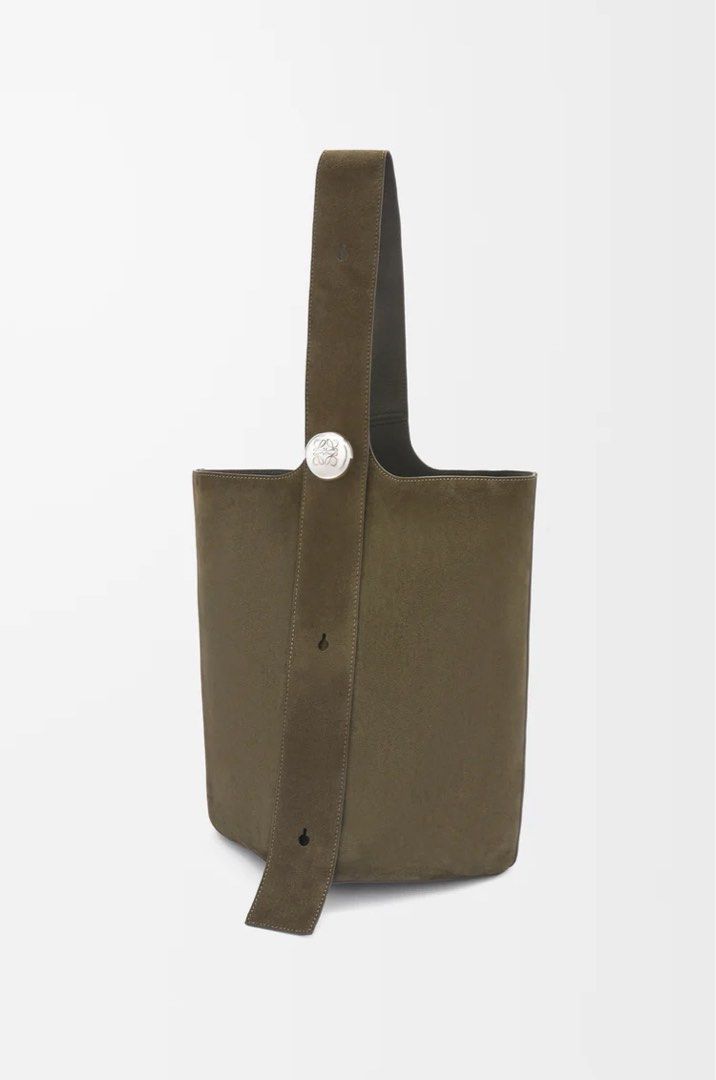 Loewe Large Pebble bucket bag in suede calfskin (Category: Bags & Wallets) located in Singapore. Submitted by danjhl (Listing ID 1367267398, Image 3). Description: Color Dark Olive. New season color! The Pebble is a minimalistic bucket bag with a wide strap adjustable through an oversized Pebble closure. This large version is crafted in suede calfskin with a smooth nappa reverse on the inside. Shoulder or crossbody carry One internal calfskin poc