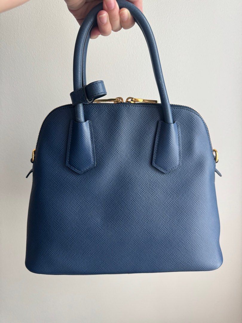 Pre-loved Prada Saffiano Cuir Dome Bag with strap (Category: Luxury Bags & Wallets) located in Pasig City. Submitted by curatedcoph (Listing ID 1367183066, Image 3). Description: Almost new With authenticity card, care card & receipt from Prada Boutique, Greenbelt Bought for P104,000 From my personal collection.