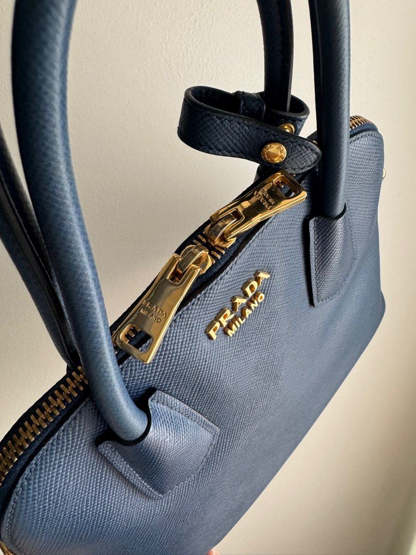 Pre-loved Prada Saffiano Cuir Dome Bag with strap (Category: Luxury Bags & Wallets) located in Pasig City. Submitted by curatedcoph (Listing ID 1367183066, Image 2). Description: Almost new With authenticity card, care card & receipt from Prada Boutique, Greenbelt Bought for P104,000 From my personal collection.