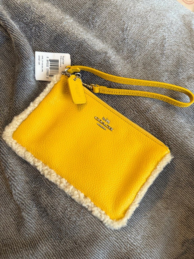 Coach Shearling and Pebbled Small Wristlet (Category: Luxury Bags & Wallets) located in Pasay City. Submitted by andreaflo (Listing ID 1367327822, Image 3). Description: • Color: Yellow/Banana 🍌 • Condition: new with tag, care instructions, & box • Super ✨cutesy✨ with faux fur trim • inside: w/ pockets for credit card .