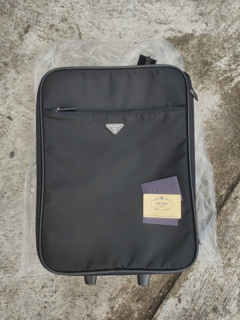Prada Luggage Trolley Maleta (Category: Luxury Bags & Wallets) located in Manila. Submitted by maxxxxxxxxxxxx (Listing ID 1367433077, Image 1). Description: for sale super nice condition Prada Trolley Maleta type bag V196 Voyage bag Vela Tela is still super nice with authenticity card leather handles and trims small dirt sa rear light wear sa body over all super Ganda pa colour and body issue is sa tires, prefer to be replaced but still works, go