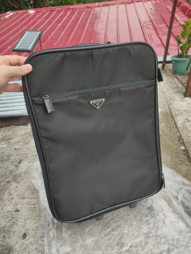 Prada Luggage Trolley Maleta (Category: Luxury Bags & Wallets) located in Manila. Submitted by maxxxxxxxxxxxx (Listing ID 1367433077, Image 2). Description: for sale super nice condition Prada Trolley Maleta type bag V196 Voyage bag Vela Tela is still super nice with authenticity card leather handles and trims small dirt sa rear light wear sa body over all super Ganda pa colour and body issue is sa tires, prefer to be replaced but still works, go