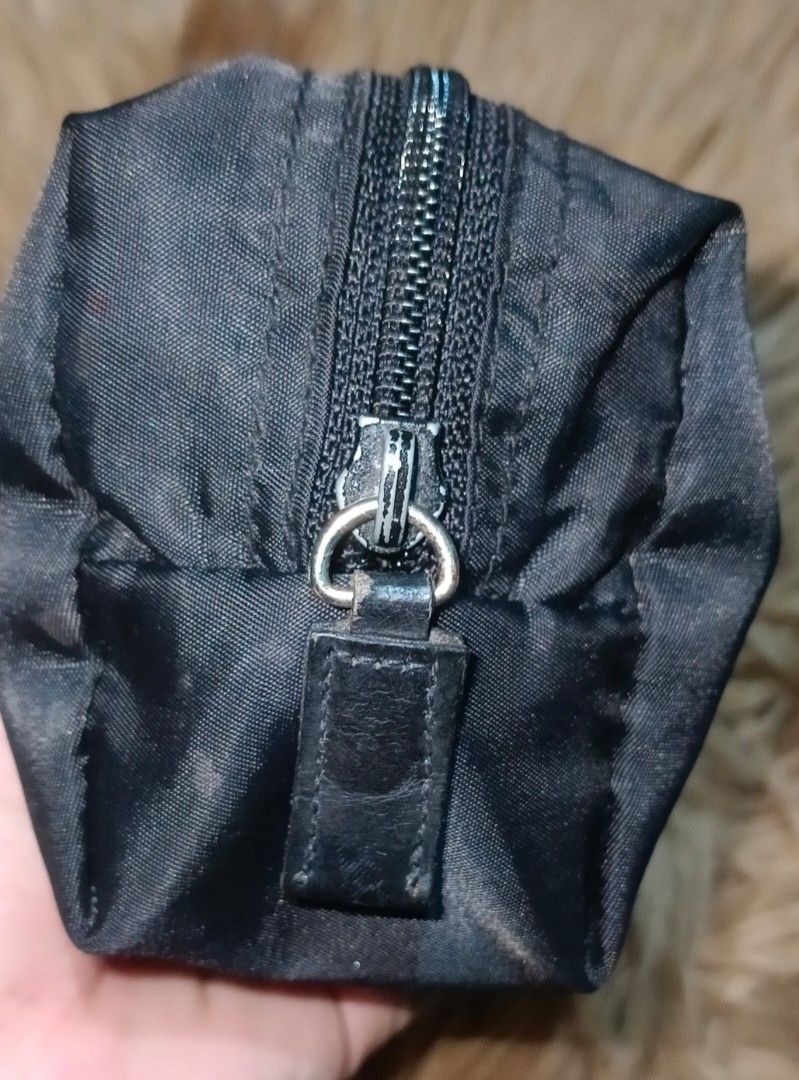 PRADA nylon pouch (Category: Luxury Bags & Wallets) located in Legazpi City. Submitted by georgepineda791 (Listing ID 1367631824, Image 2). Description: Preloved PRADA Nylon Pouch Versatile and stylish, this Prada nylon pouch is perfect for use as a cellphone holder, makeup kit, or everyday organizer. Convenient and compact, it’s a great addition to your bag essentials. Sourced from a thrift store. Note: Shows signs of usage such as slight fading