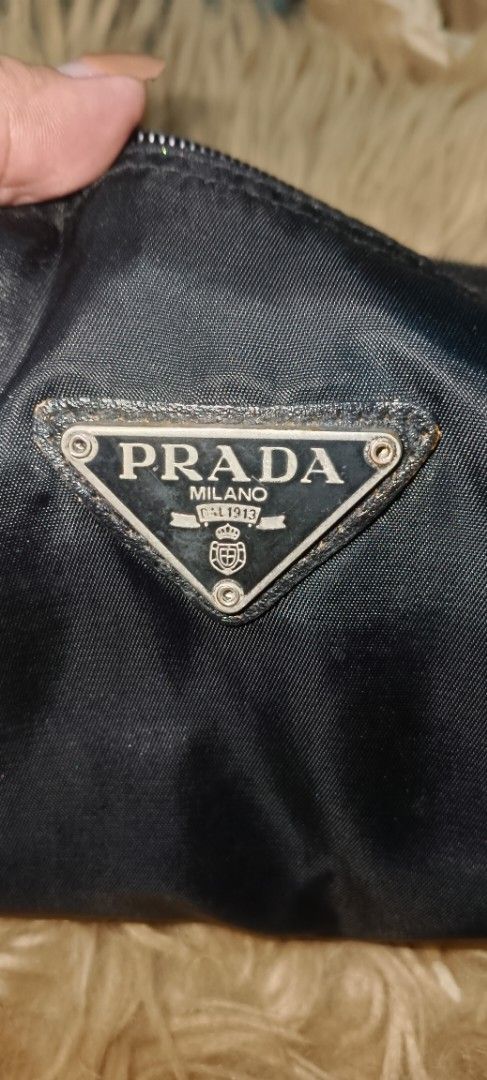 PRADA nylon pouch (Category: Luxury Bags & Wallets) located in Legazpi City. Submitted by georgepineda791 (Listing ID 1367631824, Image 3). Description: Preloved PRADA Nylon Pouch Versatile and stylish, this Prada nylon pouch is perfect for use as a cellphone holder, makeup kit, or everyday organizer. Convenient and compact, it’s a great addition to your bag essentials. Sourced from a thrift store. Note: Shows signs of usage such as slight fading