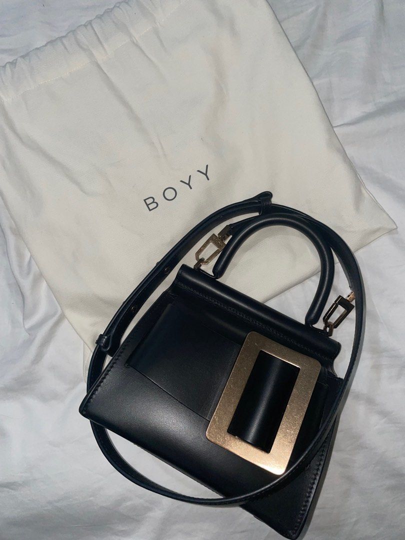 Authentic Boyy Karl 19 Black Bag (Category: Luxury Bags & Wallets) located in Quezon City. Submitted by breakmyfashion (Listing ID 1367758893, Image 1). Description: Material: Palmellato Calfskin Calfskin suede lining in ginger color. Black edge paint. Oversized metal buckle and leather belt. with single carry handle. Front flap closure. Inside zipper pocket and pouch. Adjustable and detachable leather shoulder strap. Metal feet at base. Comes wi