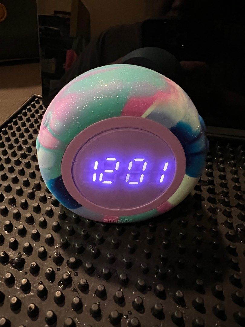 Smiggle desk clock Temperature/clock/date & alarm (Category: Clocks) located in Makati City. Submitted by affordableeleganceemporium (Listing ID 1367861433, Image 2). Description: Decorate a bedside table or homework desk with our awesome Round About Clock! Features an alarm, countdown, temperature and digital calendar display to help kickstart the day, the right way. Plus, a totally fun, space dye design! LED screen 12&24 display Alarm clock Cou