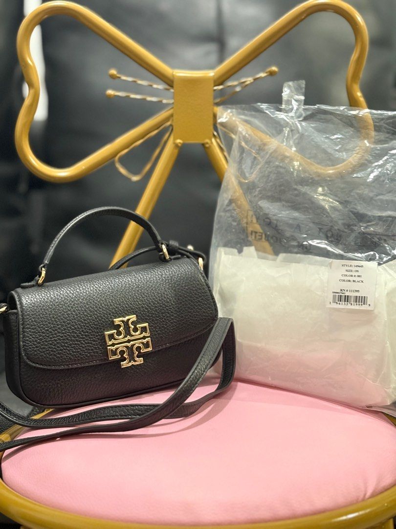 (AUTHENTIC) Tory Burch Britten Mini Top Handle Bag in Black (Category: Luxury Bags & Wallets) located in Cavite. Submitted by ._.mrjn (Listing ID 1368148364, Image 2). Description: OG Tory Burch Britten Mini Top Handle Bag ‼️ Disclaimer: Color may vary due to lighting. 🏷️ Price: ₱9,000 only + delivery fee (slightly negotiable 💰 MOP: Payment first via Gcash or PayMaya 📦 MOD: Same day delivery through Lalamove 📍 Location: Lancaster New City, Im