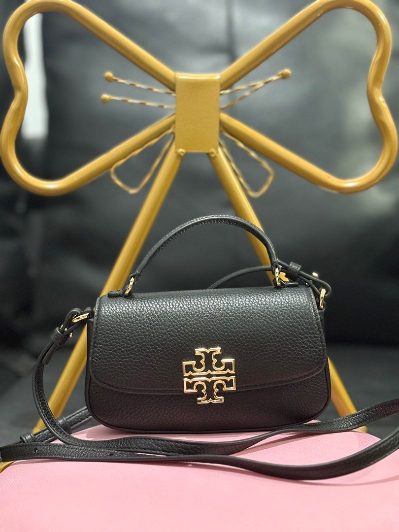 (AUTHENTIC) Tory Burch Britten Mini Top Handle Bag in Black (Category: Luxury Bags & Wallets) located in Cavite. Submitted by ._.mrjn (Listing ID 1368148364, Image 1). Description: OG Tory Burch Britten Mini Top Handle Bag ‼️ Disclaimer: Color may vary due to lighting. 🏷️ Price: ₱9,000 only + delivery fee (slightly negotiable 💰 MOP: Payment first via Gcash or PayMaya 📦 MOD: Same day delivery through Lalamove 📍 Location: Lancaster New City, Im