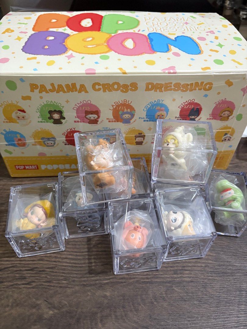 Pop Bean Pajama Cross Dressing Series (Category: Designer & Blind Box Toys) located in Las Pinas. Submitted by djcarla14 (Listing ID 1368044137, Image 1). Description: Opened bottom box to check then balik sa box. Complete inclusion. Dm me if you want more pics. - Zsiga Sitting Puppy - Zsiga Lying Lamb - Nyota Lazy Kitten - Hacipupu Purring Puppy - Kubo Cuddly Bear - Pino Jelly Gummy Bear - Pucky Cuddly Crocodile - Sweet Bean Lying Koala - Twinkl