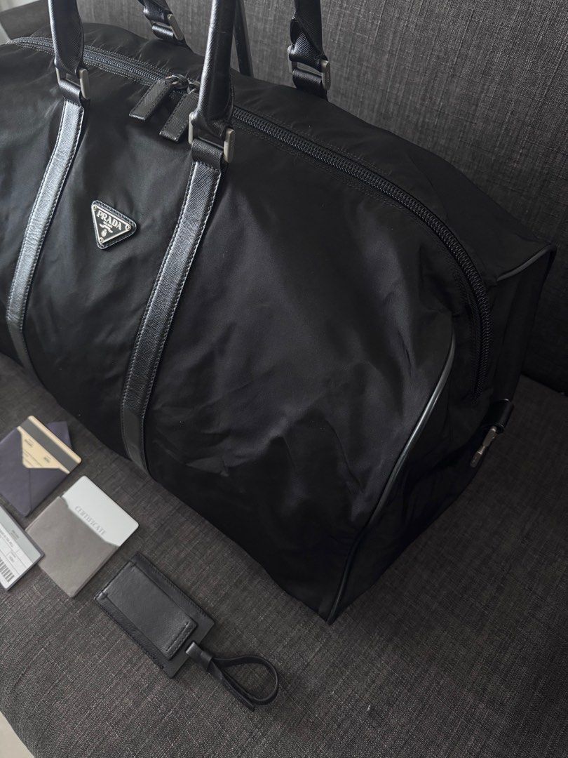 Prada Nylon Tessuto Travel Bag (Category: Luxury Bags & Wallets) located in Quezon City. Submitted by christineboller (Listing ID 1368047120, Image 3). Description: Prada Nylon Tessuto Travel Bag Height 27cm-10.5” Width 50cm-19.5” Full set, strap, lock with 2 keys, authenticity cards and bag tag for only P39k .