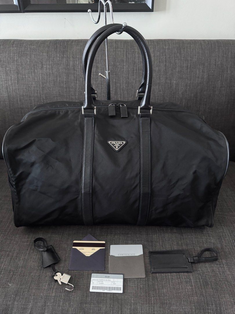 Prada Nylon Tessuto Travel Bag (Category: Luxury Bags & Wallets) located in Quezon City. Submitted by christineboller (Listing ID 1368047120, Image 1). Description: Prada Nylon Tessuto Travel Bag Height 27cm-10.5” Width 50cm-19.5” Full set, strap, lock with 2 keys, authenticity cards and bag tag for only P39k .