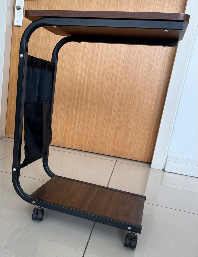 Side Table (Category: Tables & Sets) located in Kuala Lumpur. Submitted by neenawork68621 (Listing ID 1368088081, Image 2). Description: Colour - Dark Brown Movable with brake wheels and a pocket. PS: Original pocket has been replaced with a stronger satin pocket of the same size and style. Discount on the total amount if buying both. .