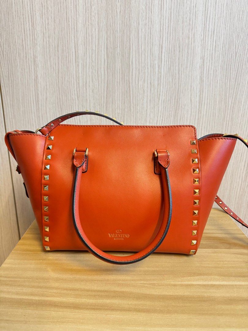 Valentino Rockstud Bag (Category: Bags & Wallets) located in Singapore. Submitted by berryyaya (Listing ID 1368148345, Image 2). Description: Pre-loved bag in good condition bought at Harrods London. Exterior leather no obvious scratches nor dents. Light scatches on metal clasp lock. Interior fabric base has some yellow spots as shown in pic 6. Size in cm (Approx): 23 (L), 21 (H), 13 (W).