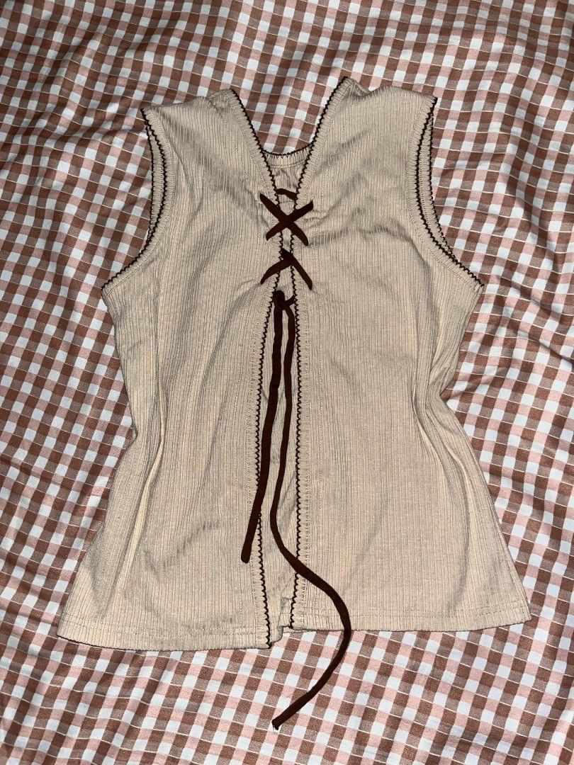 Beige tie sleeveless top (Category: Sleeveless) located in San Pablo. Submitted by sellrie (Listing ID 1372286650, Image 1). Description: can fit s-m! used once only will give a random top freebie.