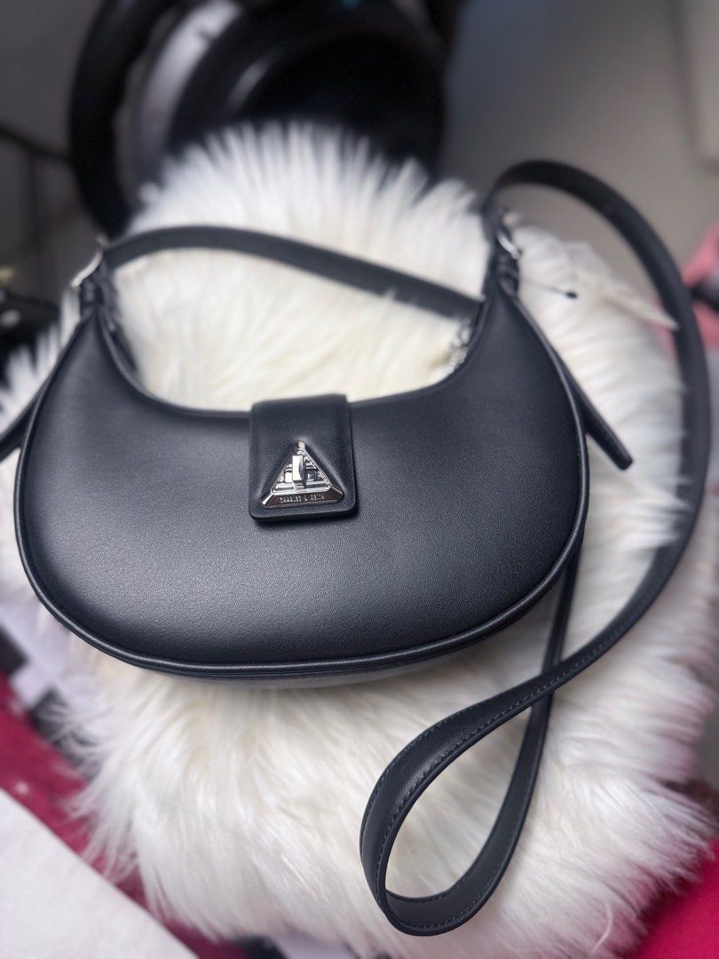 Charles & Keith Hobo Crossbody Bag (Category: Cross-body Bags) located in Cavite. Submitted by nigella02 (Listing ID 1372433389, Image 2). Description: Original Charles &Keith Crossbody Hobo type bag Guaranteed Orig Moneyback from Japan Good as New or Rank SA. Black leather and silver hardwares Can fit long wallet. No return and no exchange policy unless proven fake. Please ask for pictures to check actual condition. Gcash/Maya/Bank Transfers Loc