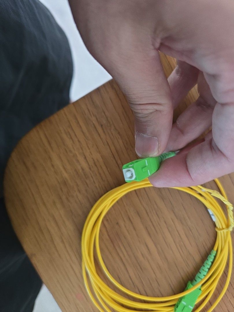 Optic fibre cable (Category: Cables & Adaptors) located in Singapore. Submitted by the_real_seller (Listing ID 1372307624, Image 2). Description: it has been used in the utility cupboard for the router for 8 years. It was not moved, so no harm to it..