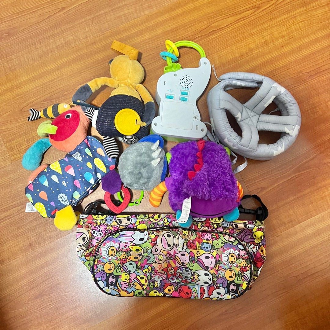 Bundle of toys ( fisherprice / moulin roty / FEHN ) (Category: Infant Playtime) located in Singapore. Submitted by jgrace.a (Listing ID 1374053259, Image 2). Description: Toys ( rattles / soft toys / musical toys ) Tokidoki stroller bag ( heavily used ) Head protector ( new ) All for $30 .