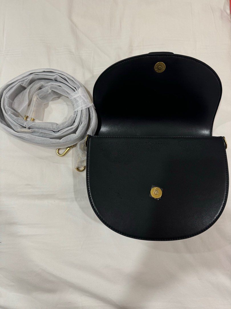 Charles and Keith Gabine Leather Saddle Bag in black (Category: Purses & Pouches) located in Singapore. Submitted by anyaparekhh (Listing ID 1374072711, Image 3). Description: Brand new Charles and Keith Gabine Leather Saddle Bag black and gold purse. Comes with long strap and dust bag. Retails for $170. .
