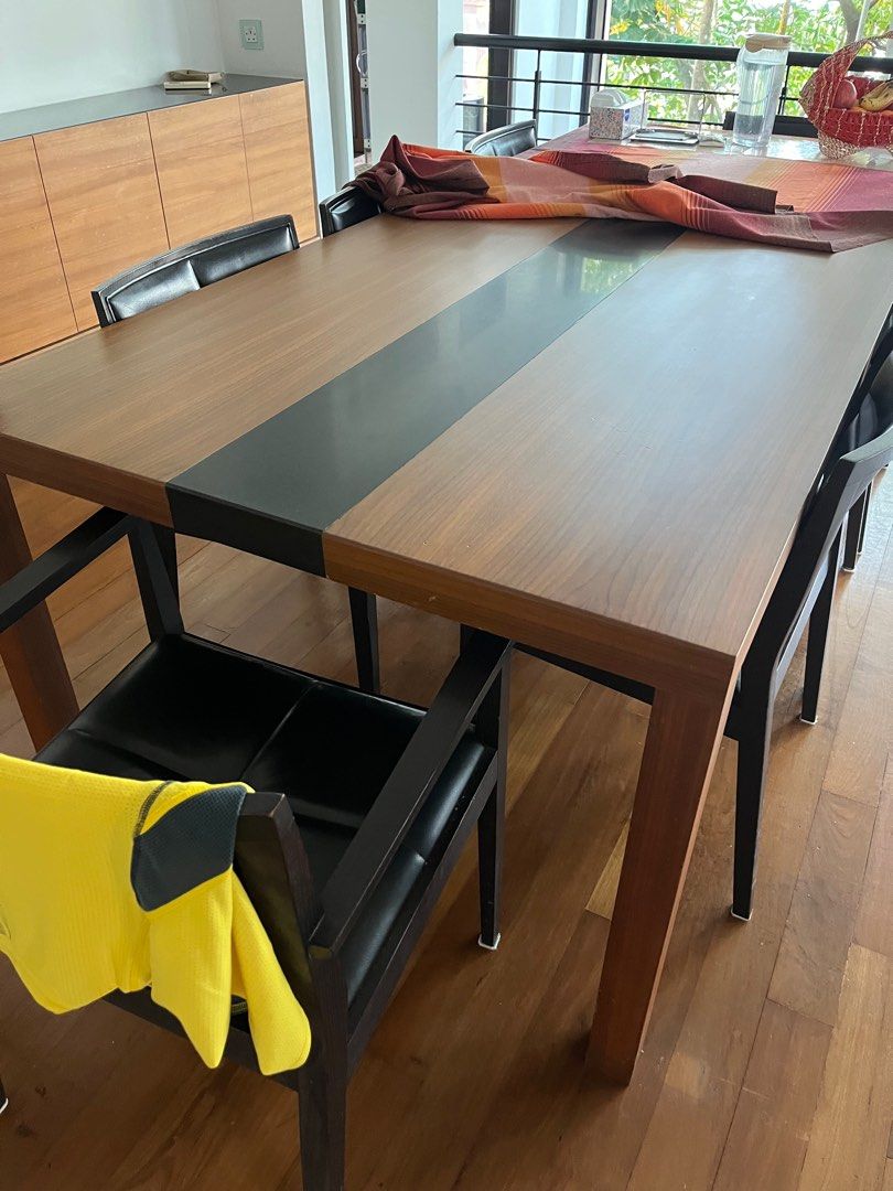 Dining Table Set (Category: Tables & Sets) located in Singapore. Submitted by pretzel8 (Listing ID 1374072637, Image 2). Description: Custom made table with 8 matching chairs that can fit 8 comfortably. 1m x 45cm. Table cannot be dismantled and was made for the house. It is always covered with a tablecloth. Leather on chairs are worn and slightly cracked but not peeling. Chairs and table can be sold separately too..