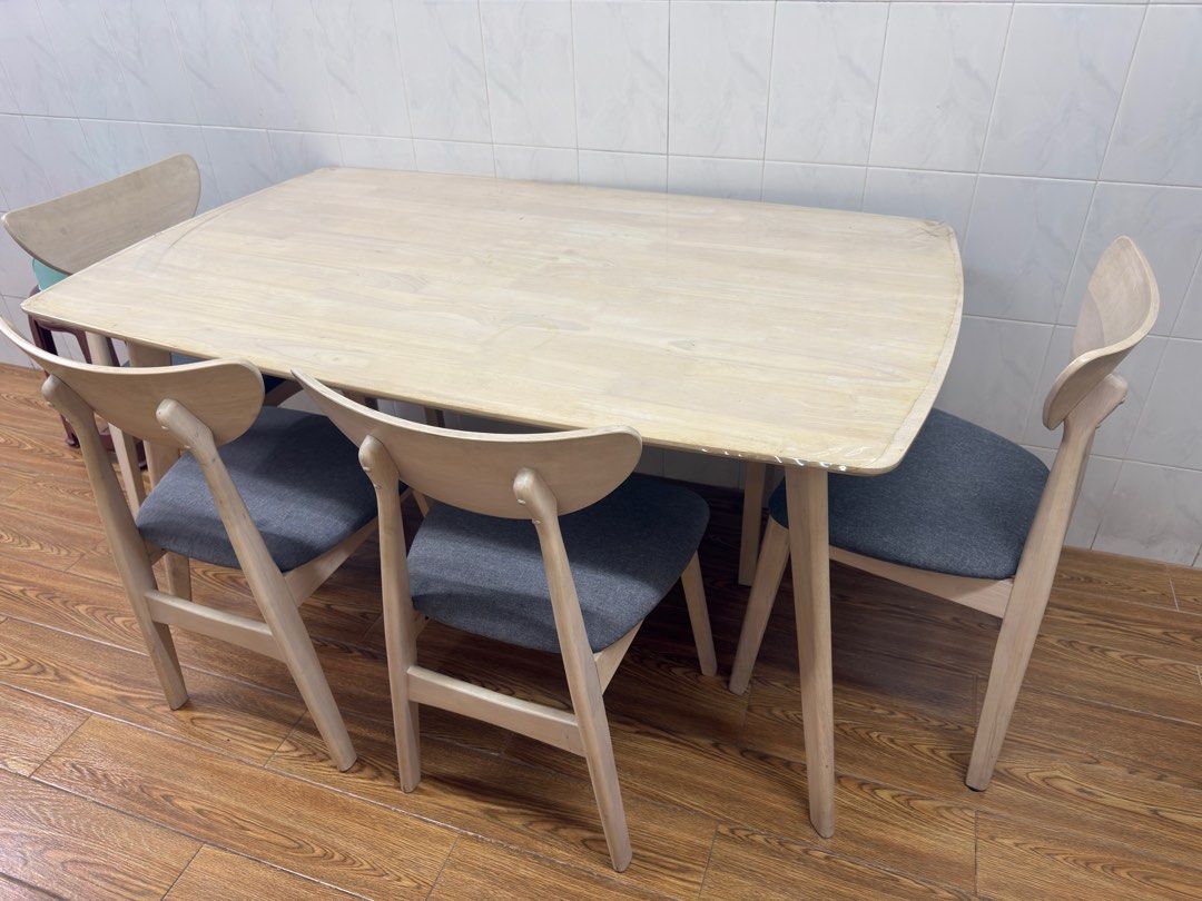 Dining Table Set (Category: Tables & Sets) located in Singapore. Submitted by durgadorita (Listing ID 1370131918, Image 1). Description: 4 grey cushioned dining chairs and a long bench that can sit upto 3pax. Seldom used and has pvc layer on top hence in very good condition. .