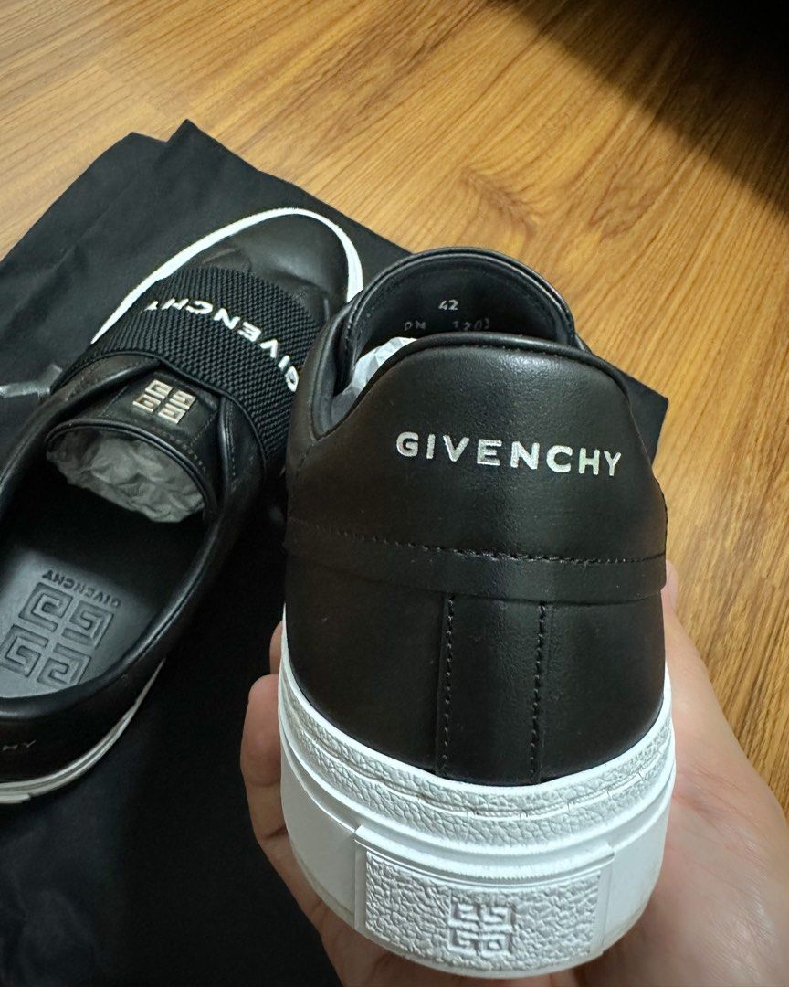 GIVENCHY City Court sneakers (Category: Sneakers & Footwear) located in Cainta. Submitted by rho77 (Listing ID 1374135506, Image 2). Description: GIVENCHY City Court Slip-On sneakers * new model * black leather with white rubber sole * elastic strap across the top * features a silver-tone metal 4G logo on the tongue and a silver Givenchy signature on the back * easy to wear * made from 100% calfskin leather * fit true to size Brand new Complete i