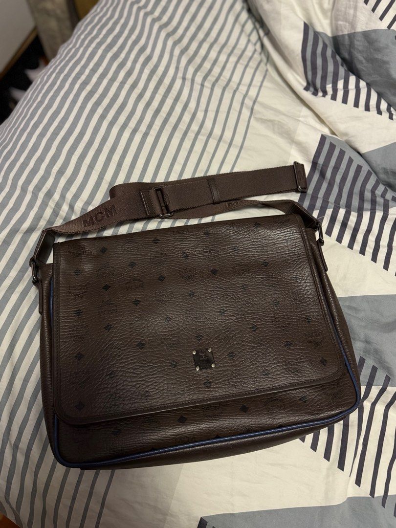Leather Laptop Bag (MCM) (Category: Luxury Bags & Wallets) located in Bocaue. Submitted by diana_ram1306 (Listing ID 1374001136, Image 2). Description: Dark brown MCM leather laptop bag Been using this for a while. Bigay lang ng tito ko. Since I bought a new one na, I will be selling this para hindi lang nakatambak sa cabinet ko hehe. No rubs on leather, all metal hardware goods pa. H 12 inches W 15 inches Issue: may small line sa center leather 