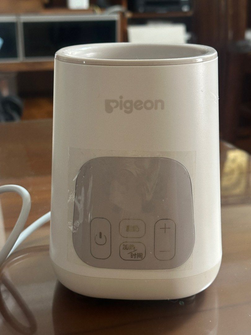 Pigeon Smart Bottle Warmer (Category: Breastfeeding & Bottle Feeding) located in Singapore. Submitted by tomi_ca (Listing ID 1374022550, Image 1). Description: - No box included - Plastic film covering the touch interface - Touch buttons still in working condition - Bottle warmer functions normally Easy to use, very light touch interface. Uses the China plug (Australian style), three flat angled pins, requires an adaptor to use. Note: Light scrat
