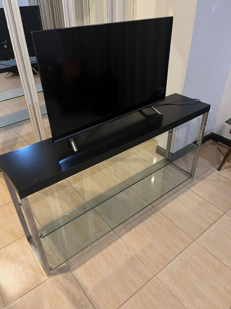 Glass / Steel Buffet Table (Category: Tables & Sets) located in Manila. Submitted by paolo_layug (Listing ID 1374269526, Image 1). Description: Glass / Steel Buffet Table - Two Levels - Can be used as a stand for TVs (TV in photo is 32" for reference) Length - 150cm Width - 35cm Height - 75cm.