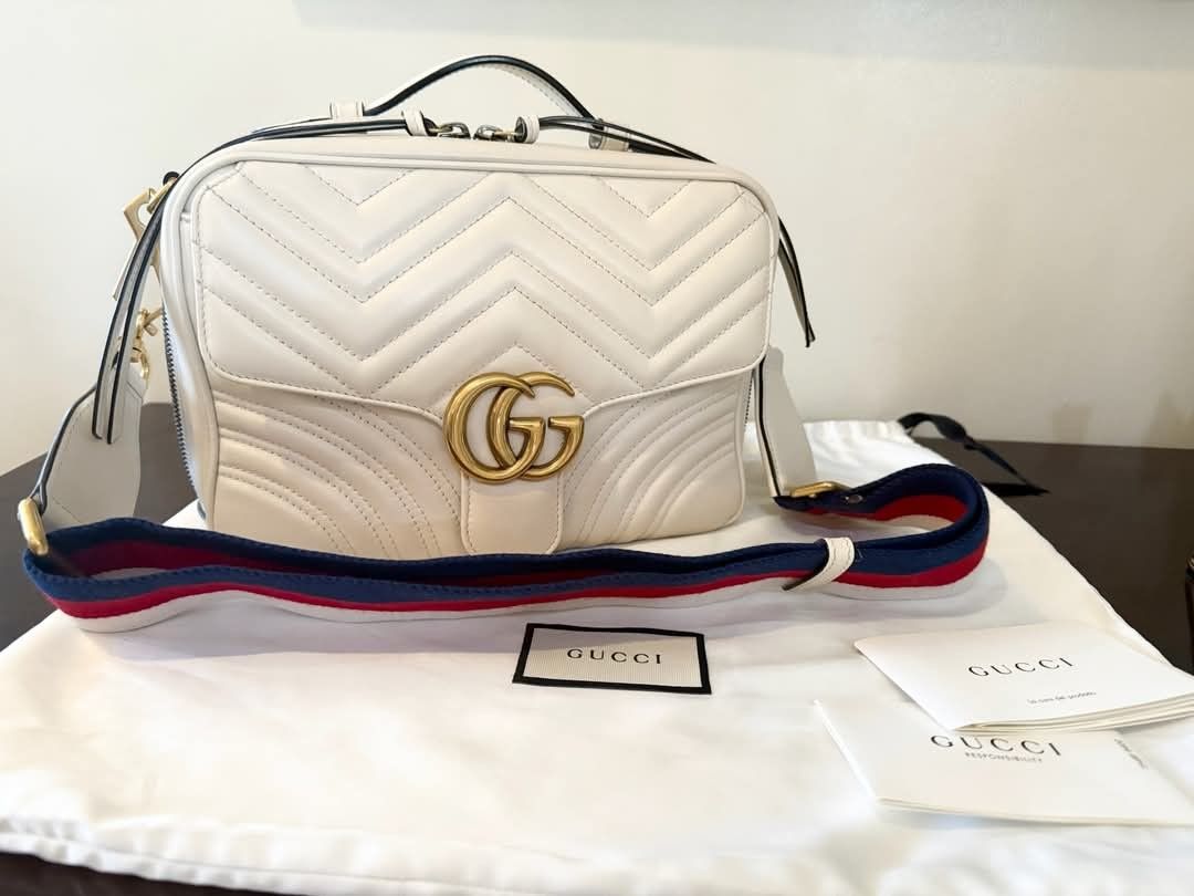 Gucci GG Marmont Top Handle with Web Strap (Category: Luxury Bags & Wallets) located in Quezon City. Submitted by gielyn2 (Listing ID 1374175291, Image 1). Description: ✨ FOR SALE: GUCCI GG MARMONT SMALL TOP HANDLE BAG with WEB STRAP ✨ 💼 LIKE NEW – Used only a few times, with no visible signs of wear! 📍 Pick-Up: Quezon City Add instant elegance to your wardrobe with this stunning Gucci GG Marmont Top Handle Bag in white chevron matelassé calfsk