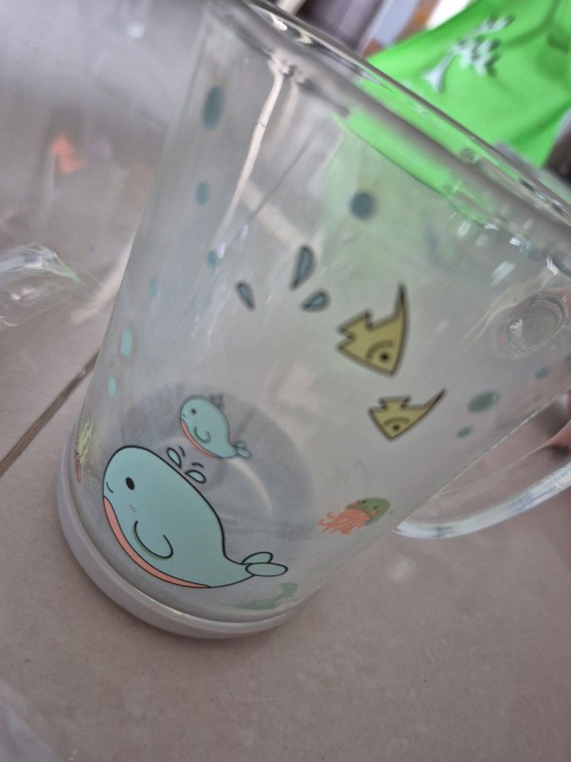 Glass cup with rubber non-slip bottom (Category: Weaning & Toddler Feeding) located in Singapore. Submitted by hidereimw (Listing ID 1374397685, Image 2). Description: never used, stored aside for a while, else i wld have listed it as brand new. glass, but with rubber non-slip bottom. more suitable for pre-schoolers or children with a firm grip and grasp. ocean animal design. comes with a cover and a straw. as seen in photo. self collect only in 