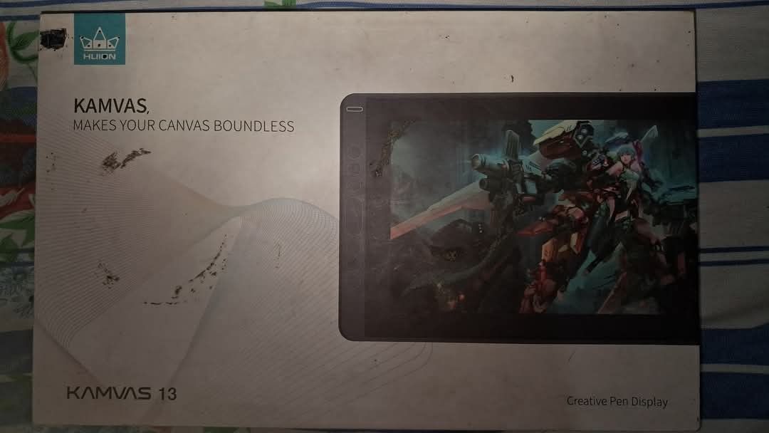 HUION Kamvas 13 Creative Pen Display (Category: Laptops & Notebooks) located in Carmona. Submitted by vivienecontemprato (Listing ID 1374343932, Image 3). Description: Condition: Used (with visible screen protector marks, some packaging wear) What’s included: - HUION Kamvas 13 Pen Display - Battery-free stylus (Pen) - Pen holder with spare nibs - USB cables (2-in-1 HDMI, USB-A to USB-C with red marking) - Quick Start Guide (Kamvas 12/13) - Origin