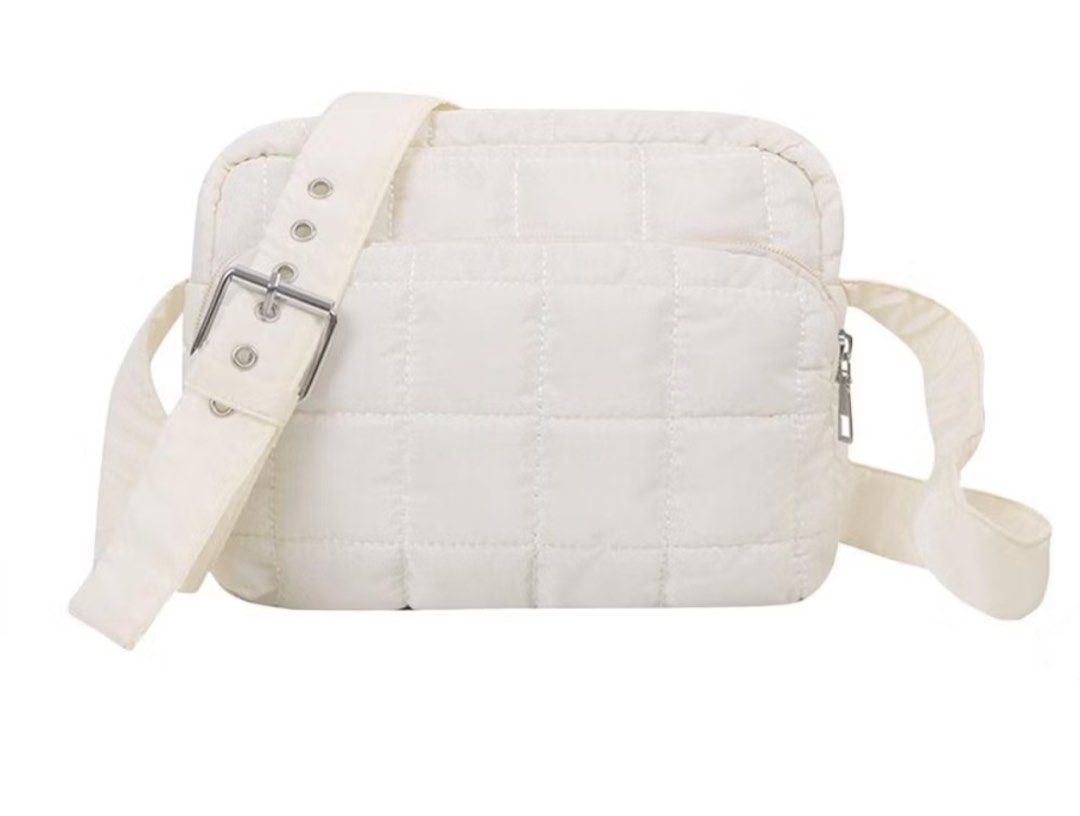 Puffy padded crossbody shoulder bag (Category: Cross-body Bags) located in Singapore. Submitted by bluetulipz (Listing ID 1374589805, Image 1). Description: Selling a small puffy plaid crossbody bag. Colour is white. Tag: Sofia label, paper bunny, tsl, tpb, mango, Zara, Charles, Pedro, puffer.