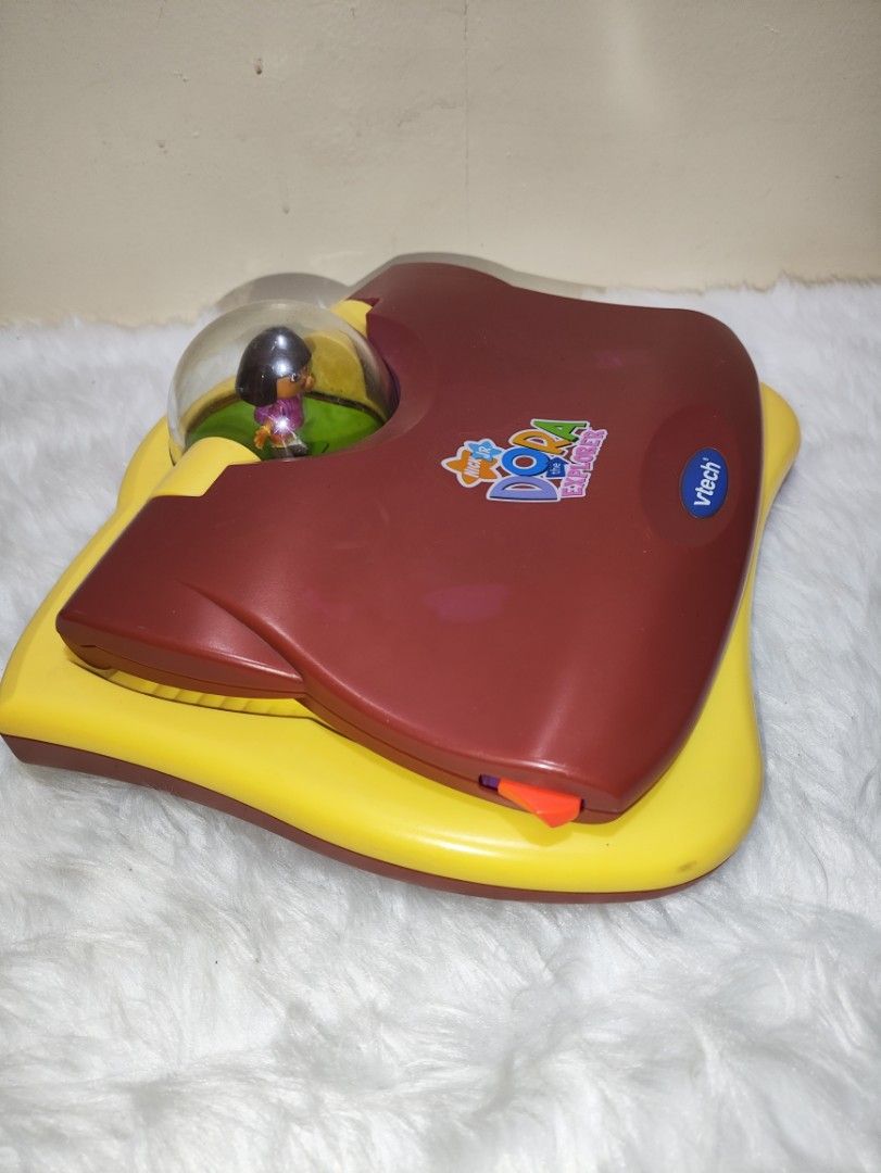 Vtech Dora The Explorer Learning Laptop (Category: Infant Playtime) located in Cavite. Submitted by tinetaclesss (Listing ID 1374751215, Image 3). Description: working issue may mga stickers po sa likod na part.