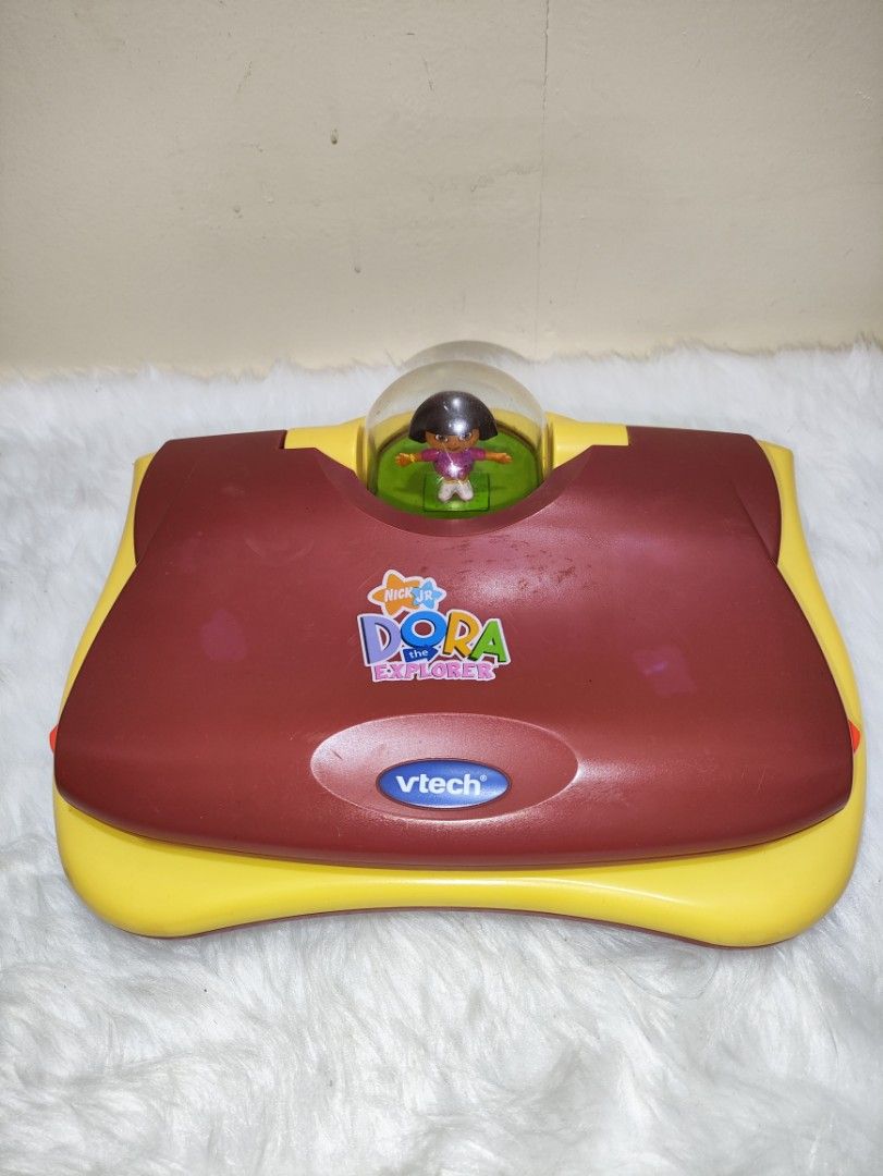Vtech Dora The Explorer Learning Laptop (Category: Infant Playtime) located in Cavite. Submitted by tinetaclesss (Listing ID 1374751215, Image 2). Description: working issue may mga stickers po sa likod na part.
