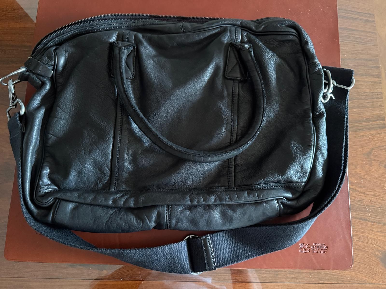 Hugo Boss Orange men's black vintage leather bag (Category: Bags & Wallets) located in Singapore. Submitted by goget88 (Listing ID 1374947530, Image 2). Description: Men's vintage leather bag with interior cloth liner, inside zipper compartment, and compartments for storing pens and other small items. Small outside pocket. Canvas/leather shoulder strap. The bag was keep in a closet and has never been used. Approximately 400 (W) x 300 (H) x 85 (D)