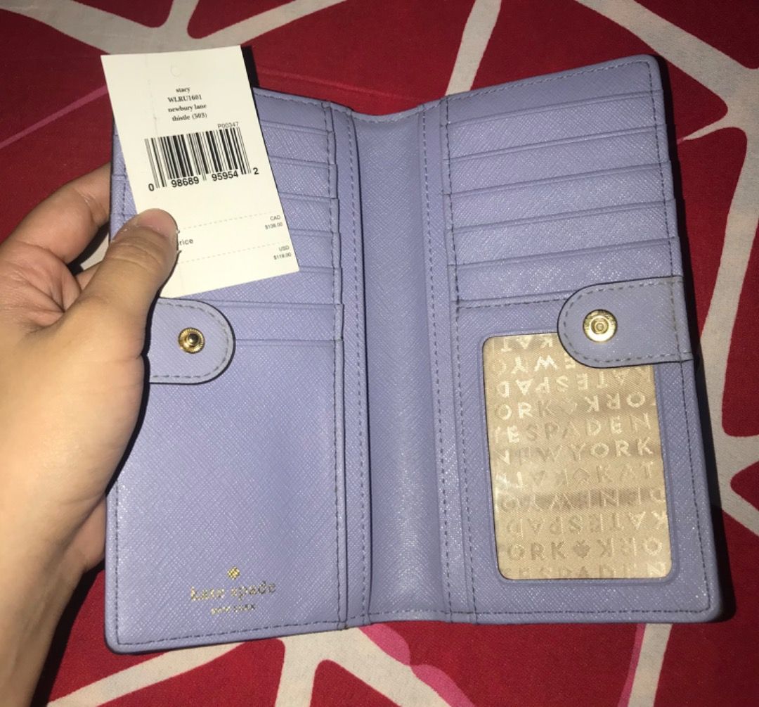 Kate Spade Stacy Bifold Wallet WLRU1601 (Category: Luxury Bags & Wallets) located in General Trias. Submitted by karinator (Listing ID 1375180976, Image 2). Description: ORIGINAL Kate Spade Newbury Lane Stacy Bifold Wallet WLRU1601 [Lilac-Coloured]. Bought for 138 CAD = PHP 5,300. Slightly used, only needs cleaning. RFS: Not my style e 😅 Nakatambak lang sa bahay. You can send me a message if you want more pictures. Price a bit negotiable for sur