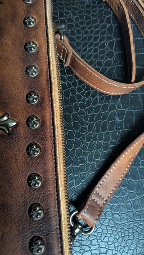 Leather bag - Designed with beautiful rivets (Category: Luxury Bags & Wallets) located in Cavite. Submitted by luckygingerivy (Listing ID 1375158457, Image 3). Description: Genuine cowhide leather. Can be worn as a sling, shoulder, or clutch bag. Given to me as a gift, not my style. Adjustable and removable straps. 11.5 x 7.5 dimensions..