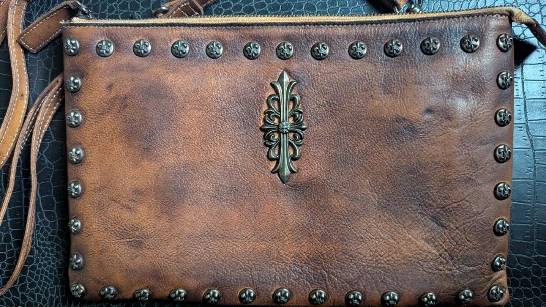 Leather bag - Designed with beautiful rivets (Category: Luxury Bags & Wallets) located in Cavite. Submitted by luckygingerivy (Listing ID 1375158457, Image 1). Description: Genuine cowhide leather. Can be worn as a sling, shoulder, or clutch bag. Given to me as a gift, not my style. Adjustable and removable straps. 11.5 x 7.5 dimensions..