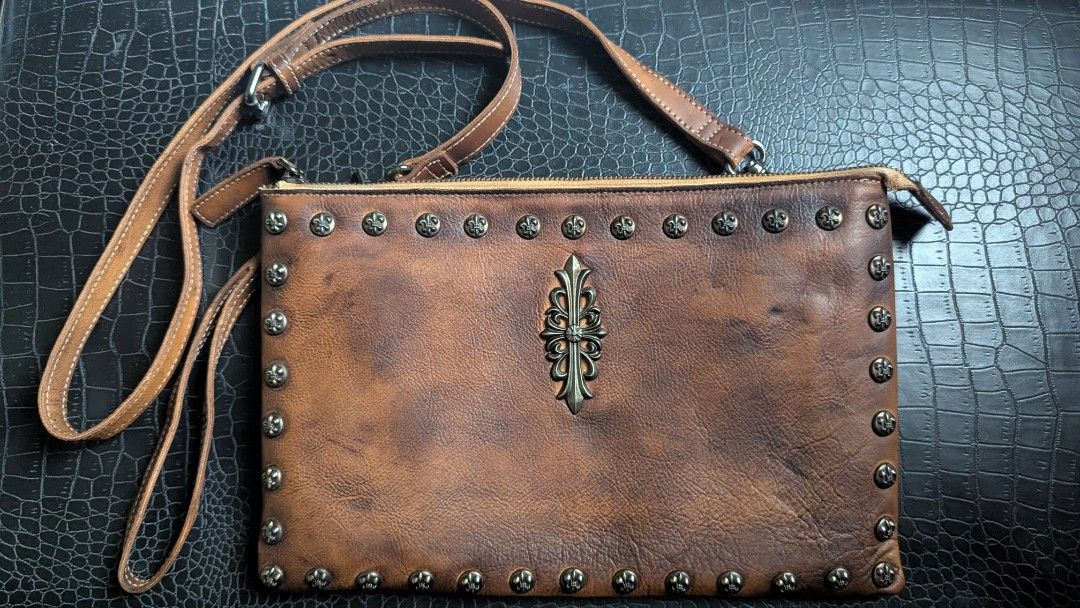 Leather bag - Designed with beautiful rivets (Category: Luxury Bags & Wallets) located in Cavite. Submitted by luckygingerivy (Listing ID 1375158457, Image 2). Description: Genuine cowhide leather. Can be worn as a sling, shoulder, or clutch bag. Given to me as a gift, not my style. Adjustable and removable straps. 11.5 x 7.5 dimensions..