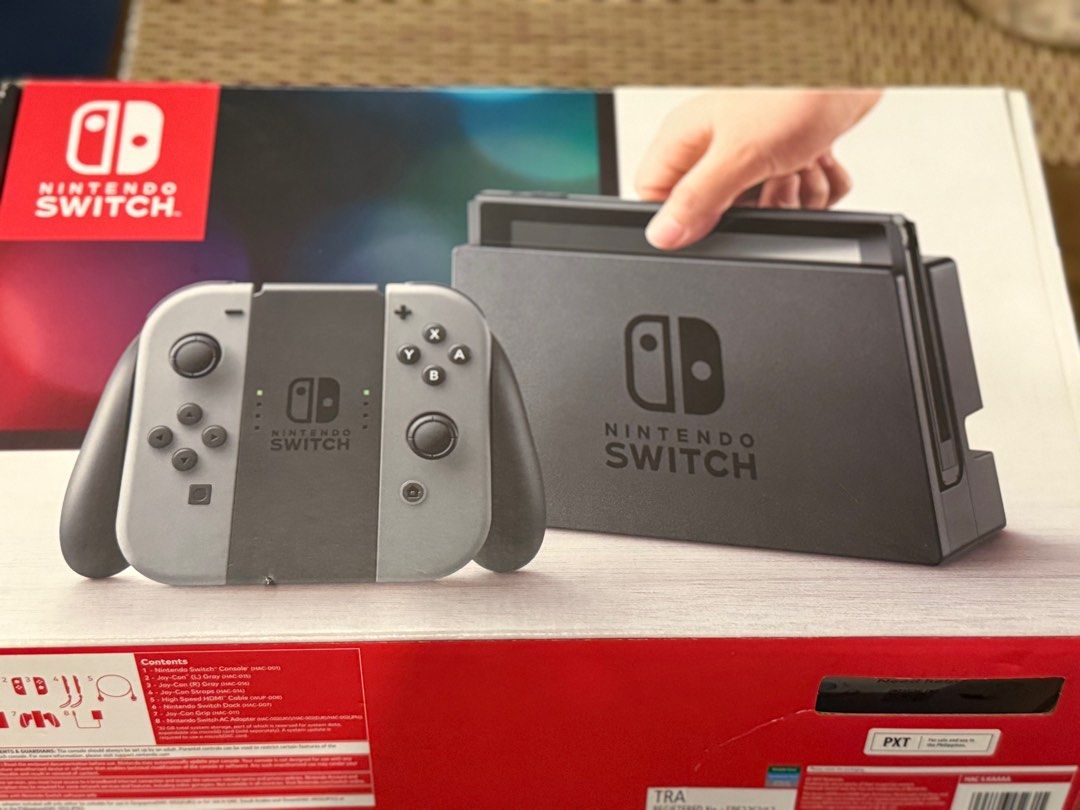 Nintendo Switch V1 Grey (Category: Nintendo) located in Taguig. Submitted by stan.ph (Listing ID 1375216143, Image 3). Description: RFS - Upgrade to Nintendo Switch 2 Nintendo Switch V1 * Fully working with minor issues * In almost good condition * Can’t be jailbreaked * No SD card * No games, console only Includes: * Console with Grey Joy-Cons * Joy-Con Straps * Joy-Con Grip * Nintendo Switch Dock with AC Adapter and HDMI Cable * HORI Case (can 