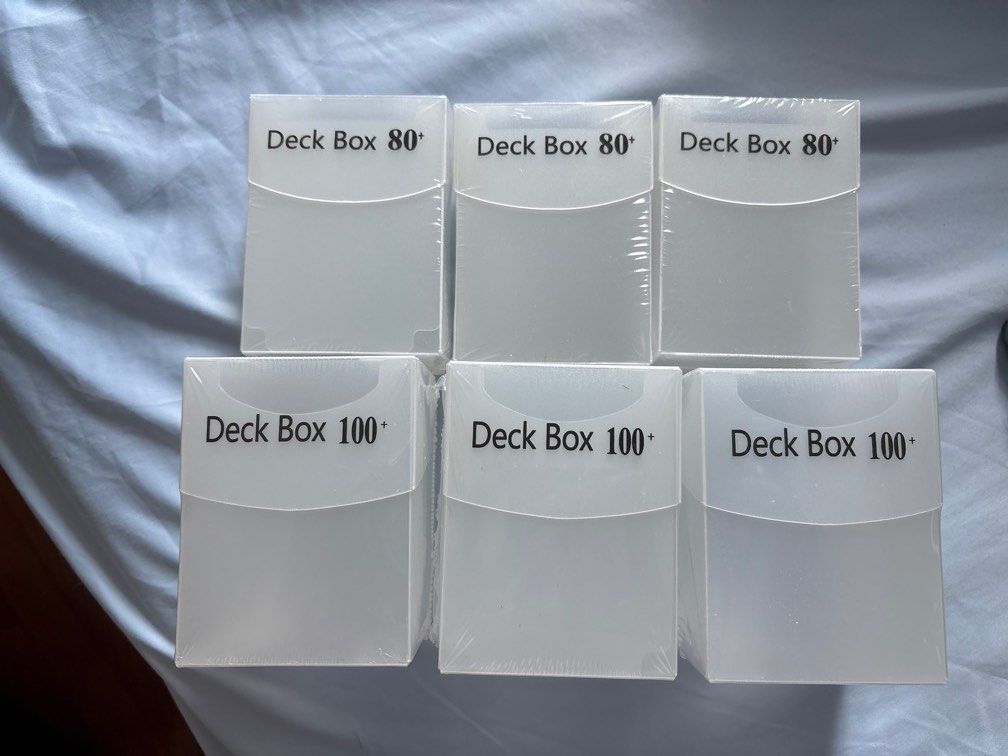 Translucent deck boxes (Category: Trading Cards Accessories) located in Singapore. Submitted by manonabudget (Listing ID 1375121896, Image 1). Description: Comes with free deck divider of same colour. More quantity available than shown. 80+ card deck box: $1 100+ card deck box: $1.5 (Sold Out).