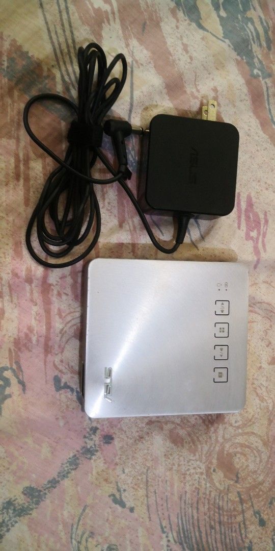 ASUS S1 Portable Projector (Category: Office & Business Technology) located in Dagupan City. Submitted by ptrvncnt (Listing ID 1375381147, Image 1). Description: Old Projector. But used at most 100 hours. For emergency lang noon pag brownout. 200 lumens only so not very bright like big projectors. Rechargeable. Maganda pa ang itsura. No major scratches. Pero sa screen pag dark na ang background may konting white dots sa ibat ibang places. Hindi s