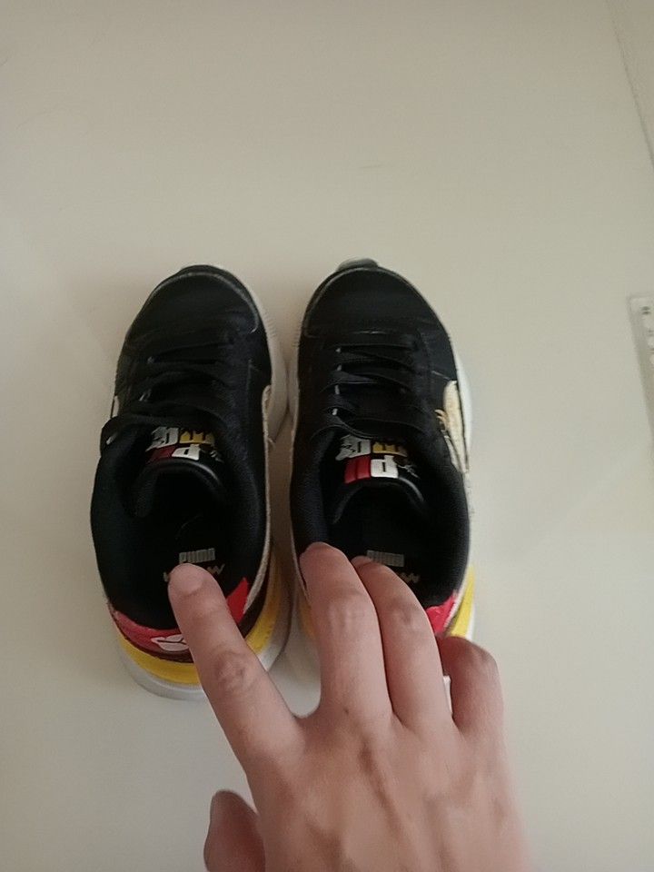 Puma x Peanuts Black Sneakers (Category: Babies & Kids Fashion) located in Singapore. Submitted by busy4nothing (Listing ID 1375314180, Image 2). Description: Check out these Puma x Peanuts sneakers! They've been worn a lot times, so there's some wear and tear, especially around the edges, but overall, they're still in good shape. The Snoopy design is super cute, and the colors are vibrant. The soles look pretty good too, with some minor wear. Th