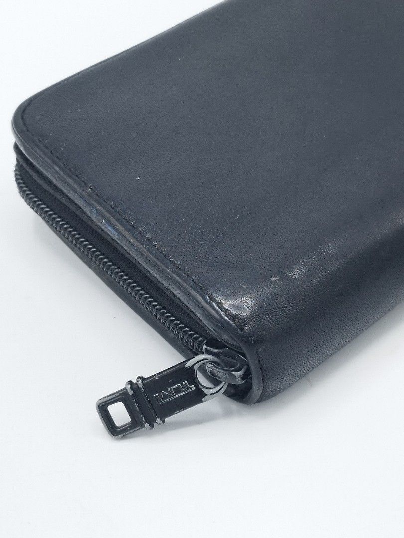 TUMI Delta Zip-around Travel Wallet (Category: Belt bags, Clutches and Pouches) located in Quezon City. Submitted by redragtag (Listing ID 1375375932, Image 3). Description: Authentic TUMI Delta Travel wallet - Sleek and functional accessory for organising travel documents and valuables. - It features a Zip-around closure, multiple compartments for cards, cash, and passport. - Made from durable, full-grain napa leather. Condition: Very good. Ther