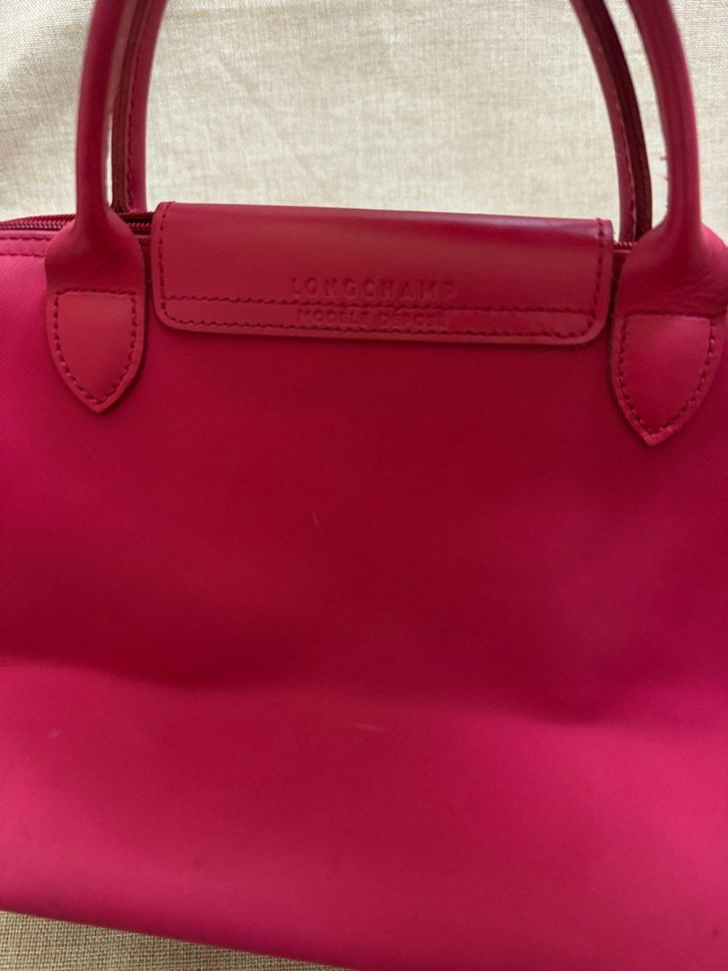 Longchamp Modele Depose Deep Pink (Category: Luxury Bags & Wallets) located in San Jose. Submitted by aldieph (Listing ID 1375622377, Image 2). Description: Height: 21cm Length: upper - 14cm, bottom - 20cm Width: 14cm Signs of usage, minimal ink stains Good rubber linings Overall good Issue: see photos Note: Color may vary due to camera lighting Please expect normal signs of usage if not brand new 599 + SF No Return, no exchange - shop w/ discret